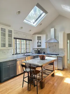 a kitchen with a table with chairs and a skylight at Woodsy Chic Family-Friendly Spacious Getaway in Lake Arrowhead