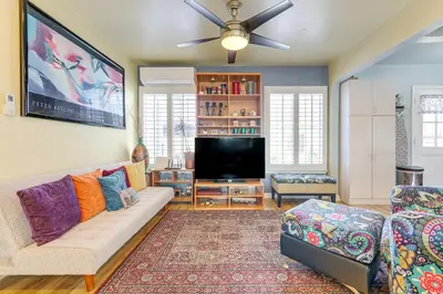 a living room with a couch and a flat screen tv at Stylish Home Near SoFi Stadium, LAX and Long Beach in Compton