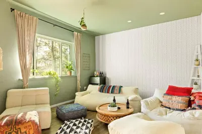 a living room with a couch and a table at Lumiere Cabin in Lake Arrowhead