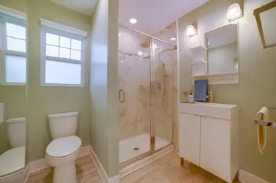 a bathroom with a shower and a toilet and a sink at Walk to Festival of Lights Cozy Couples Retreat in Riverside