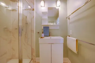 a white bathroom with a sink and a shower at Walk to Festival of Lights Cozy Couples Retreat in Riverside