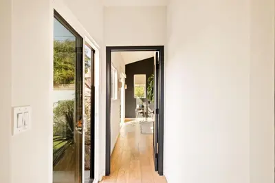 a hallway with a door leading into a house at LA Oasis with Private Yard 10 min to Beach LAX 405 in Los Angeles