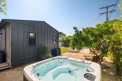 a hot tub in a yard next to a building at LA Oasis with Private Yard 10 min to Beach LAX 405 in Los Angeles