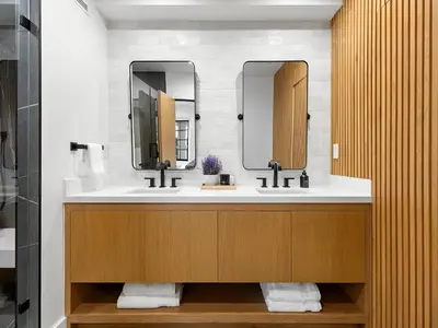 a bathroom with two sinks and two mirrors at Villa Costera in Malibu Beach