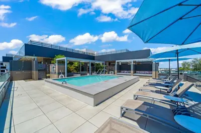 a house with a swimming pool and some chairs at Stylish Condo Mins to Shoreline in Long Beach