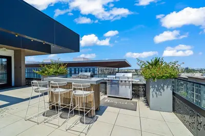 a patio with a bar and a kitchen on a building at Stylish Condo Mins to Shoreline in Long Beach