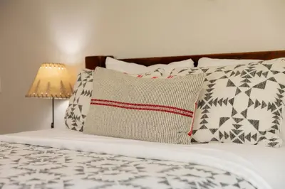 a bed with a pillow and a lamp on it at View On the Rocks Scenic Mountain Oasis with Hot Tub, Fire Pit and Game Room in Big Bear Lake