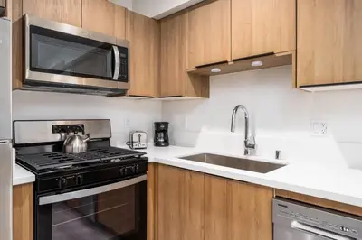 a kitchen with a stove and a microwave at Cozy LA Getaway Fast Wi-Fi and Smart TV in Los Angeles