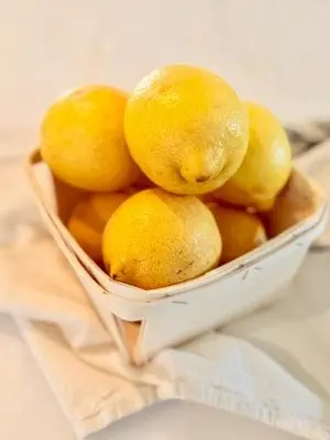 a white bowl filled with lemons on a table at Hillside Haven - Boutique Spanish Escape in Ojai