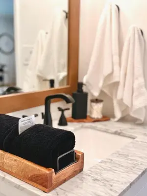 a black towel sitting on a bathroom counter in front of a mirror at Hillside Haven - Boutique Spanish Escape in Ojai