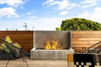 a fire pit in the middle of a patio at Hip Venice 5BR 4BA Home w Rooftop and Steps to the Beach in Los Angeles
