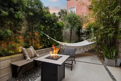a patio with a hammock and a fire pit at Hip Venice 5BR 4BA Home w Rooftop and Steps to the Beach in Los Angeles