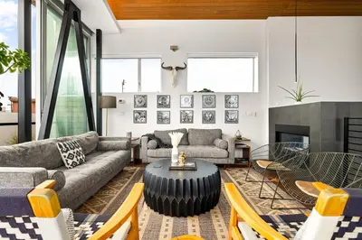 a living room with a couch and a table at Hip Venice 5BR 4BA Home w Rooftop and Steps to the Beach in Los Angeles