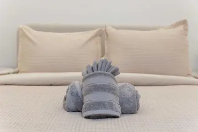 a childs hand with a sock on a bed at The W Hotel Residence With Roof Top Pool, Gym Plus 2 Free Valet Parking spaces in Los Angeles