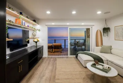 a living room with a couch and a television at Malibu Breeze in Malibu Beach