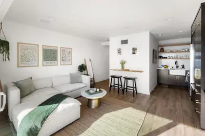 a living room with a white couch and a table at Malibu Breeze in Malibu Beach
