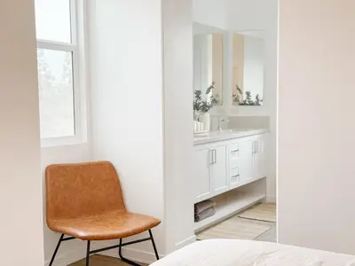 a bathroom with a chair next to a sink at Central, Urban Townhouse with Private Roof Deck in Garden Grove