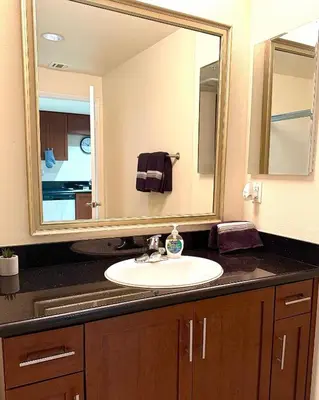 a bathroom with a sink and a large mirror at Downtown LA Urban Escape in Los Angeles