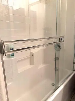 a glass shower door in a bathroom with a tub at Downtown LA Urban Escape in Los Angeles