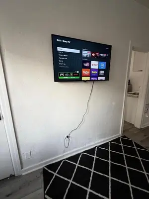 a flat screen tv hanging on a wall at Westlake MacArthur Park Studio in Los Angeles