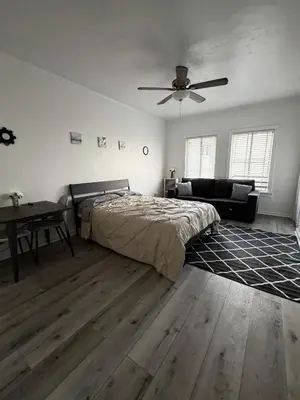a bedroom with a bed and a ceiling fan at Westlake MacArthur Park Studio in Los Angeles