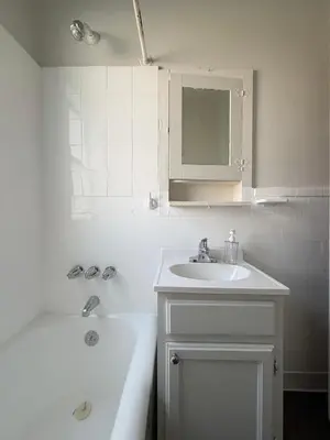 a bathroom with a sink and a tub and a mirror at Wilshire Center K-Town Studio in Los Angeles