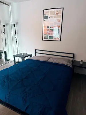 a bedroom with a bed with a blue comforter at Steps from The Hollywood Walk of Fame in Los Angeles