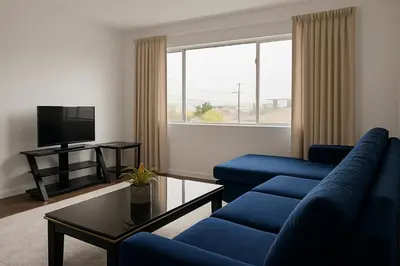 a living room with blue couches and a tv at Kenmore relax in Los Angeles