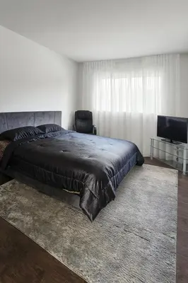 a bedroom with a bed and a chair and a television at Kenmore relax in Los Angeles