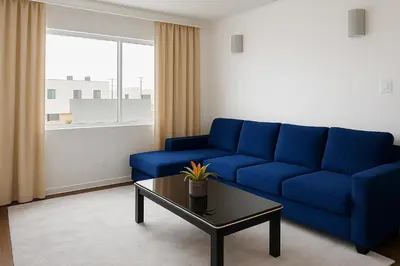 a living room with a blue couch and a coffee table at Kenmore relax in Los Angeles