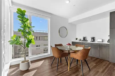 a dining room with a table and chairs and a window at Amethyst Sky Loft - Elevated Two-Story Waterfront in Los Angeles