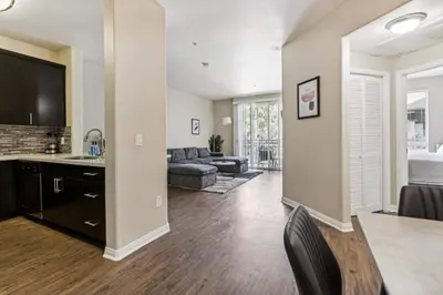 a living room with a couch and a table and a television at Cozy Marina Hideaway Gym Pool & Spa Central in Los Angeles