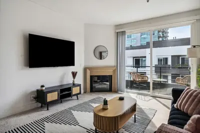 a living room with a tv and a fireplace at Modern Marina Sanctuary Central Pool Gym Spa in Los Angeles