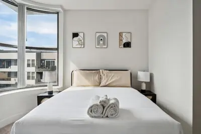 a bedroom with a bed with two shoes on it at Modern Marina Sanctuary Central Pool Gym Spa in Los Angeles
