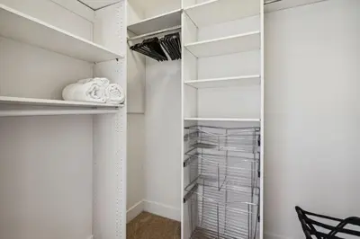 a walk in closet with white walls and a glass door at Modern Marina Sanctuary Central Pool Gym Spa in Los Angeles