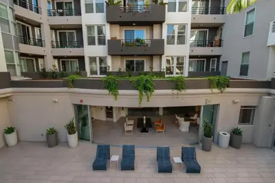 an apartment building with chairs and tables in a courtyard at Daybreak MDR in Los Angeles