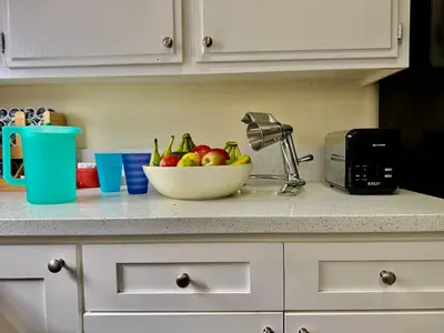 a bowl of fruit on a counter in a kitchen at Proper Stays at Melrose - West Hollywood Premium M suite in Los Angeles