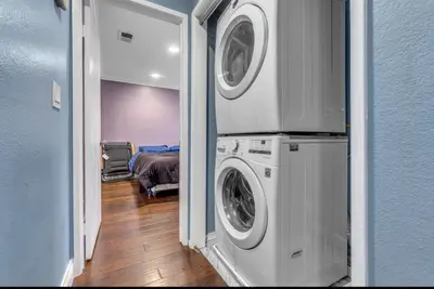 a room with two washing machines and a bedroom at 2 Bed Apartment with Private Terrace Near SoFi in Los Angeles