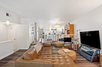 a living room with a couch and a tv at Elsa House in Warner Center Plaza One Heliport