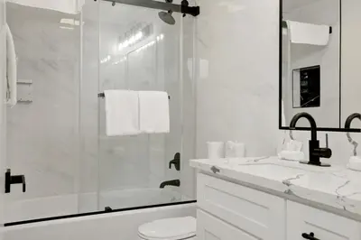 a bathroom with a shower and a toilet and a sink at Stairway to Heaven at Big Bear- Million Dollar Lake Views - Modern Luxury Chalet w/ Hot Tub in Big Bear Lake