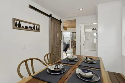 a dining room with a table with two chairs at Stairway to Heaven at Big Bear- Million Dollar Lake Views - Modern Luxury Chalet w/ Hot Tub in Big Bear Lake