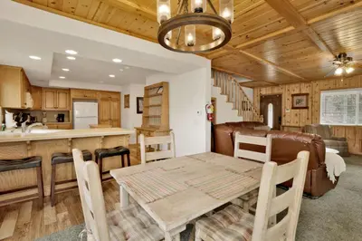 a dining room and kitchen with a table and chairs at Brownie Retreat Walk-to-Summit Mountain Getaway for Snowboarders & Skiers in Big Bear Lake