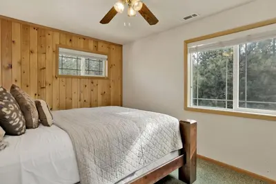 a bedroom with a bed and a window at Brownie Resort Retreat Walk-to-Ski Snow Summit Duplex Getaway in Big Bear Lake