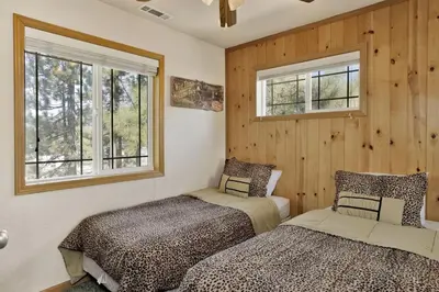 two beds in a room with two windows at Brownie Resort Retreat Walk-to-Ski Snow Summit Duplex Getaway in Big Bear Lake