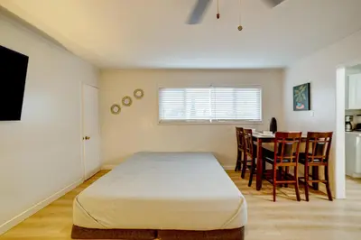 a room with a bed and a table and chairs at Work and Play! Studio 7 Mi to Dtwn San Bernardino in Rialto