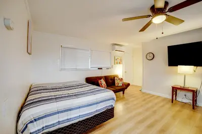 a bedroom with a bed and a flat screen tv at Work and Play! Studio 7 Mi to Dtwn San Bernardino in Rialto