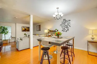 a kitchen and living room with a table and stools at Home 1 Mi to UC Riverside Families Welcome! in Riverside