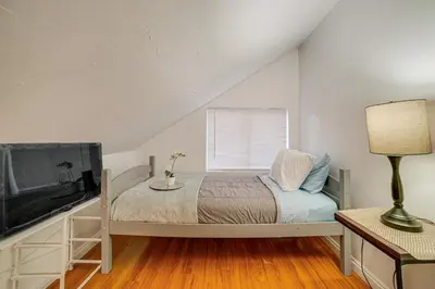 a bedroom with a bed and a flat screen tv at Home 1 Mi to UC Riverside Families Welcome! in Riverside