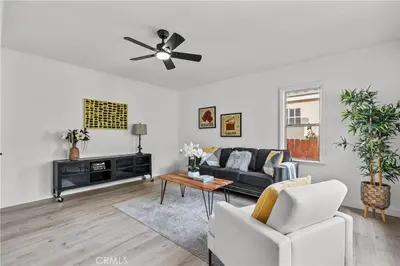 a living room with a couch and a ceiling fan at Fully Furnished 1-Bedroom in Los Angeles