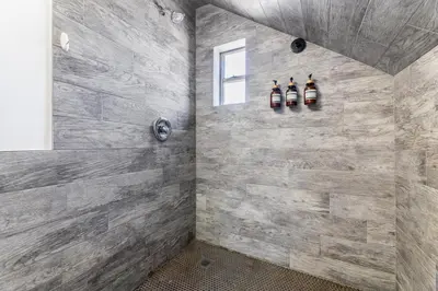 a bathroom with a stone wall at Hawthorne Haven Spacious 4BR Retreat in Hawthorne